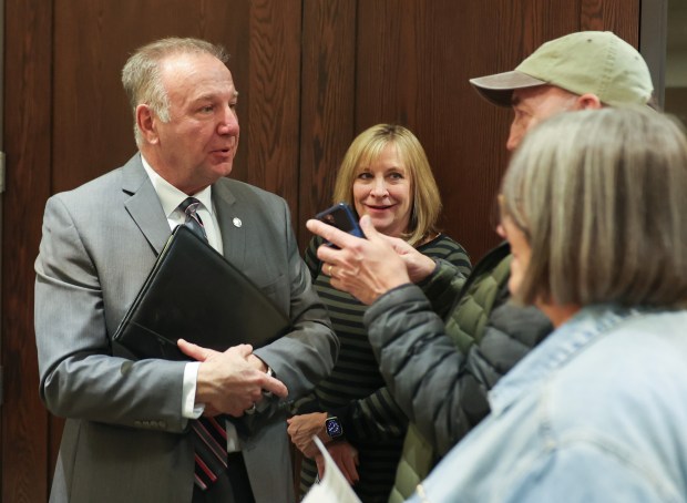 Then-Arlington Heights mayoral candidate Jim Tinaglia, left, speaks with voters after a candidates forum on March 13, 2025. (Stacey Wescott/Chicago Tribune)