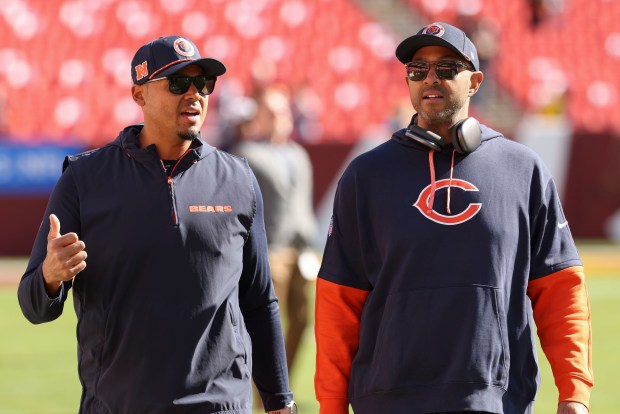 Bears general manager Ryan Poles, left, and assistant GM Ian Cunningham walk the field before a game against the Commanders. (Brian Cassella/Chicago Tribune)