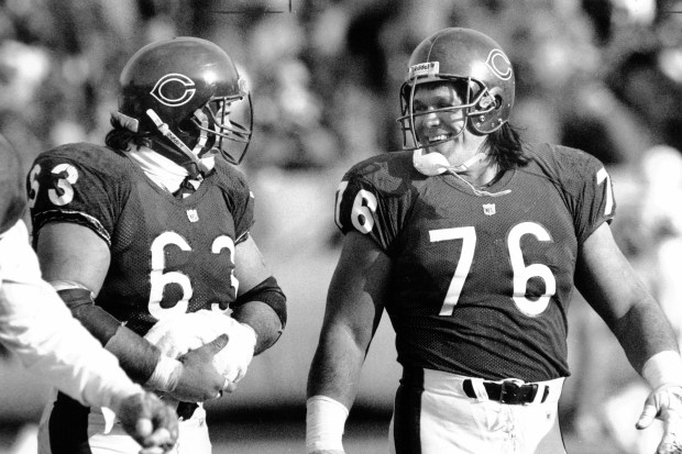 Steve McMichael lights up in a smile as he and...