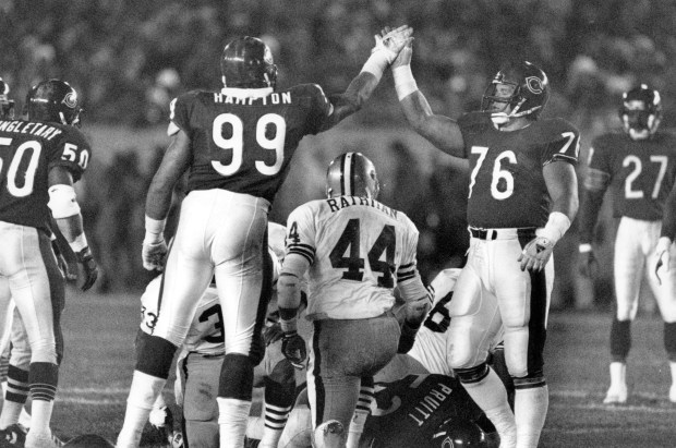 The Bears' Dan Hampton exchanges high-fives with Steve McMichael after...
