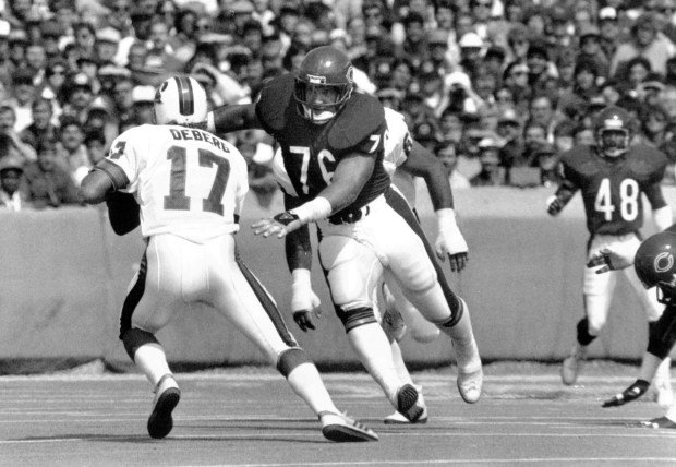 The Bears’ Steve McMichael bears down on Tampa’s Steve DeBerg...