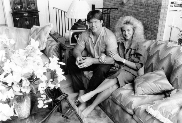 Steve and Debra McMichael sit in the living room of...