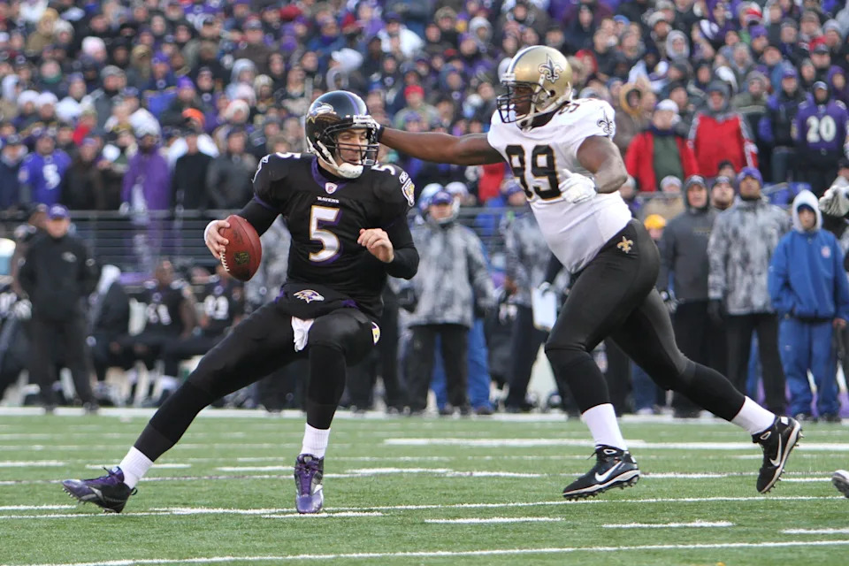 December 19, 2010; Baltimore, MD, USA; Baltimore Ravens quarterback Joe Flacco (9) is sacked by New Orleans Saints defensive lineman Jimmy Wilkerson (99) at M&T Bank Stadium. The Ravens beat the Saints 30-24. Mandatory Credit: Mitch Stringer-USA TODAY Sports