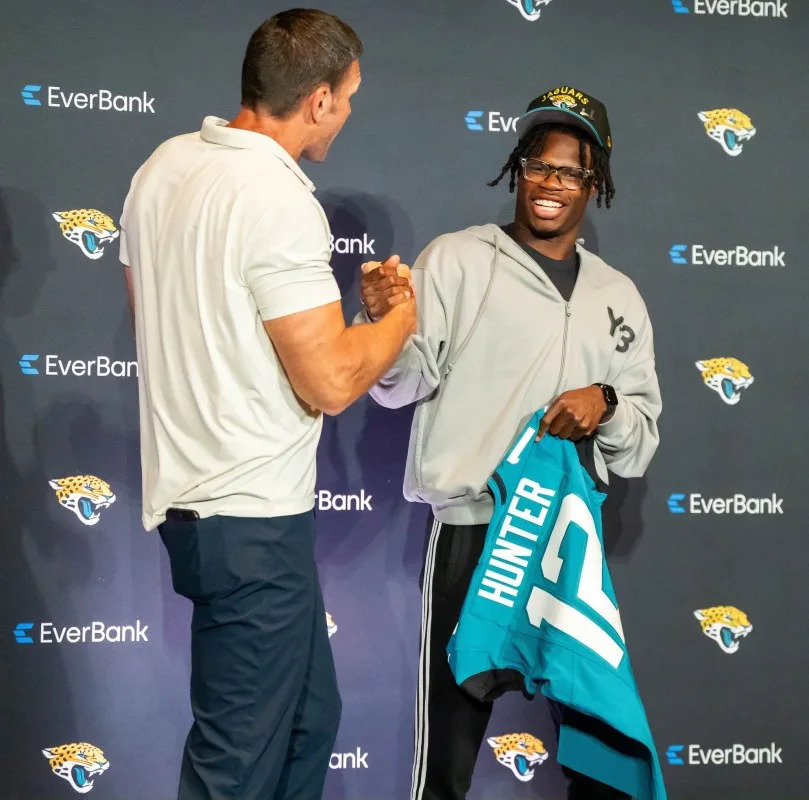 The Jacksonville Jaguars’ first-round pick, Colorado Buffaloes wide receiver and defensive back Travis Hunter, right, jokes around with Tony Boselli, Executive Vice President of Football Operations, left, after a press conference Friday, March 25, 2025 at Miller Electric Center in Jacksonville, Fla. [Doug Engle/Florida Times-Union]Doug Engle&sol;Florida Times-Union