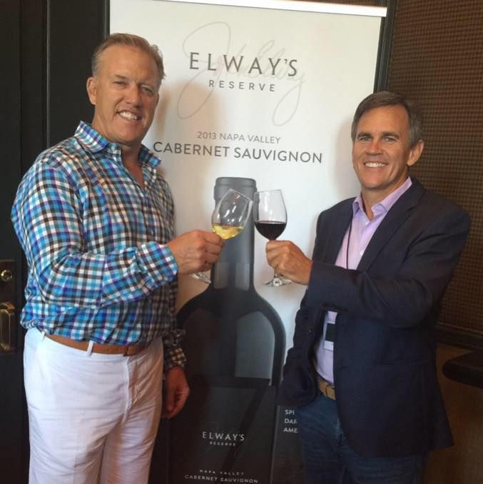 John Elway and Jeffrey Sperbeck were business partners, they hold glasses of wine in this picture