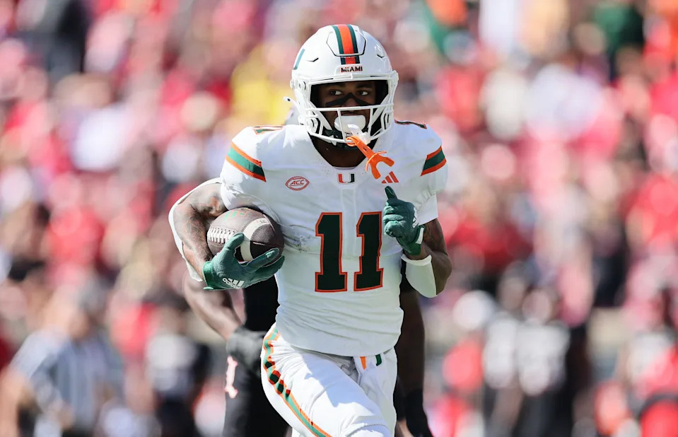 Sam Brown Jr. of the Miami Hurricanes runs for a touchdown against the Louisville Cardinals.
