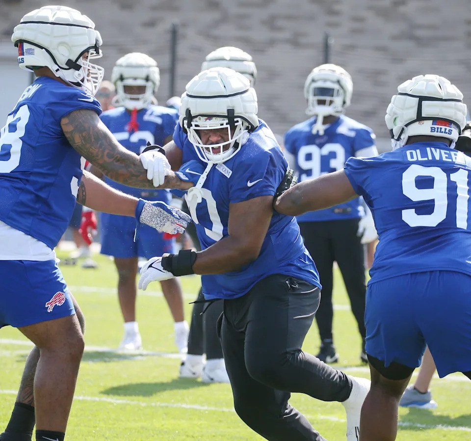 Bills defensive tackle DeWayne Carter splits between Austin Johnson, left, and Ed Oliver during defensive line drills.