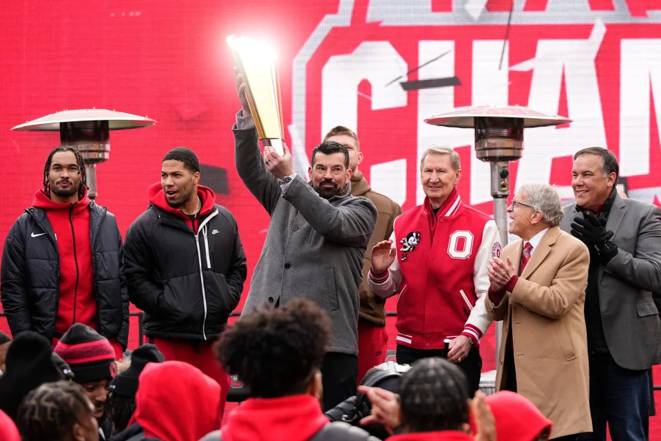 Ohio State Buckeyes head coach Ryan Day hoists the championship trophy during the Ohio State Buckeyes College Football Playoff National Championship celebration at Ohio Stadium in Columbus on Jan. 26, 2025.