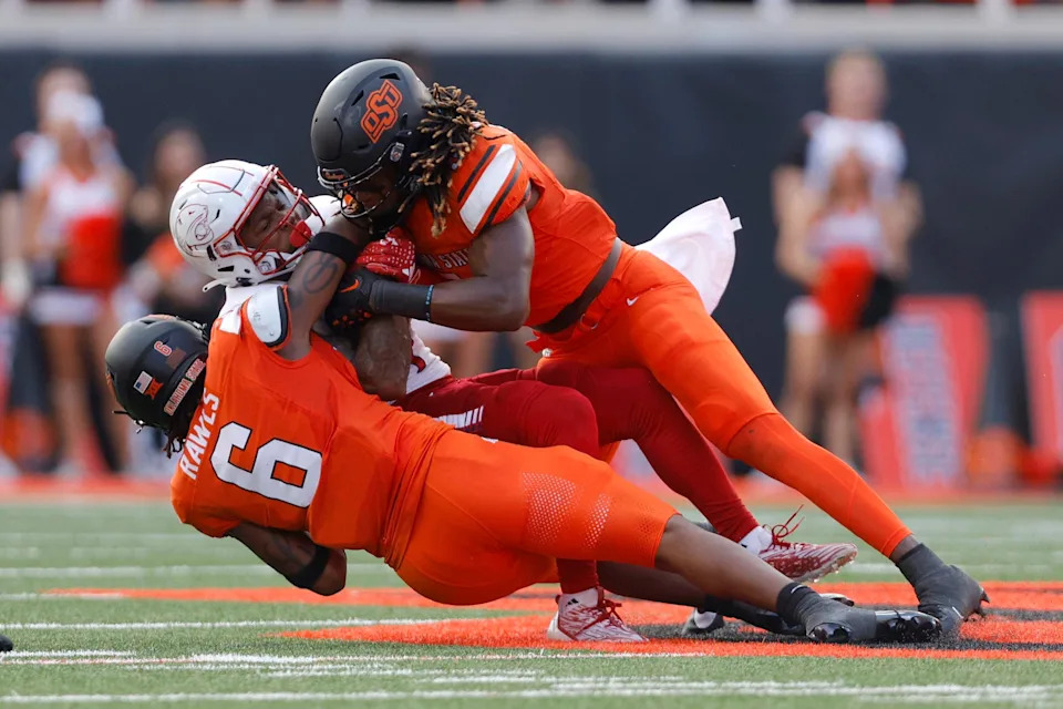 Sep 16, 2023; Stillwater, Oklahoma, USA; Oklahoma State Cowboys safety Lyrik Rawls (6) and Oklahoma State Cowboys safety Kendal Daniels (5) bring down South Alabama Jaguars wide receiver Caullin Lacy (4) during an NCAA football game between Oklahoma State and South Alabama at Boone Pickens Stadium. South Alabama won 33-7. Mandatory Credit: Bryan Terry-USA TODAY Sports