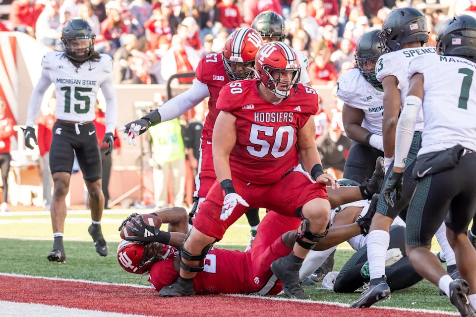 Nov 18, 2023; Bloomington, Indiana, USA; Indiana Hoosiers running back Trent Howland (27) falls into the end zone for a touchdown during the second quarter against the Michigan State Spartans at Memorial Stadium. Mandatory Credit: Marc Lebryk-USA TODAY Sports