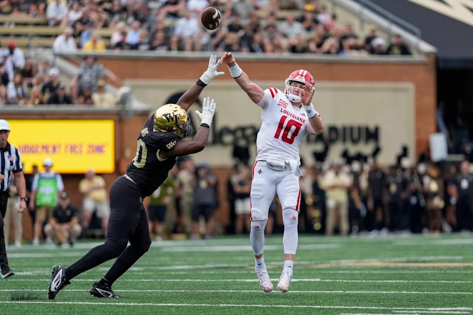 Louisiana-Lafayette Ragin Cajuns quarterback Ben Wooldridge (10) throws under pressure from Wake Forest Demon Deacons defensive lineman Jasheen Davis (30). Mandatory Credit: Jim Dedmon-Imagn Images