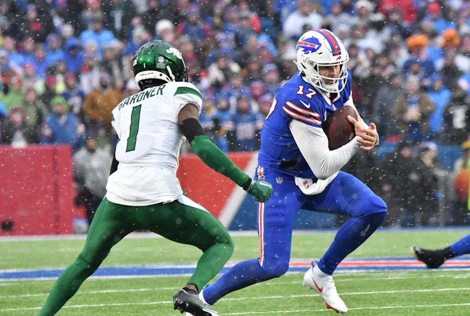 Buffalo Bills quarterback Josh Allen (17) runs the ball against New York Jets cornerback Sauce Gardner (1).Mark Konezny-Imagn Images