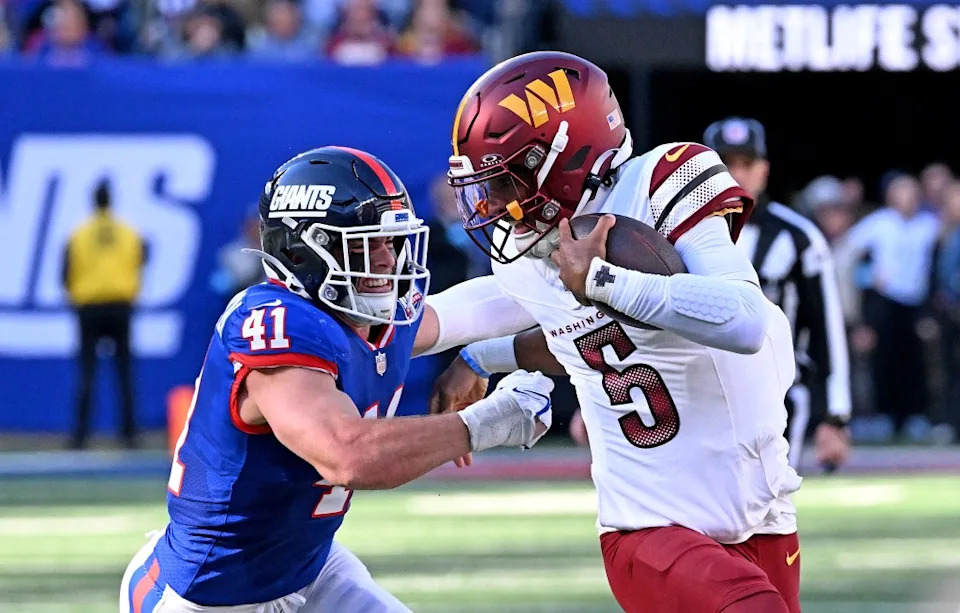 Commanders quarterback Jayden Daniels stiff arms Micah McFadden #41 of the New York Giants while running the ball during the second quarter of a game in East Rutherford, N.J. on November 3, 2024. Bill Kostroun/New York Post