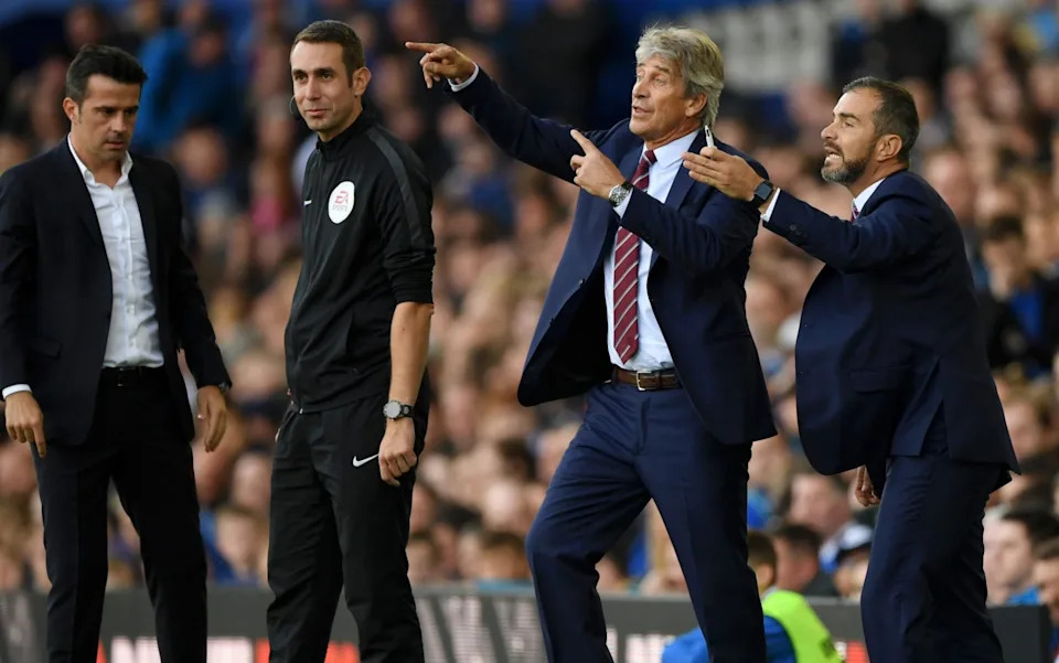 Manuel Pellegrini, manager of West Ham United, and assistant coach, Enzo Maresca give their team instructions