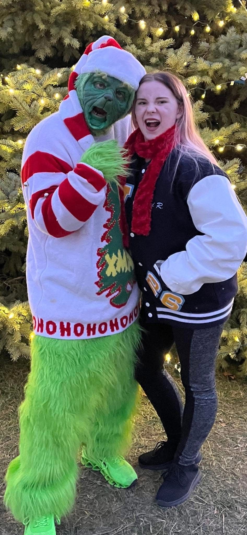 Brian, whose dressed up as Marion's Grinch for over a decade, poses with his daughter.