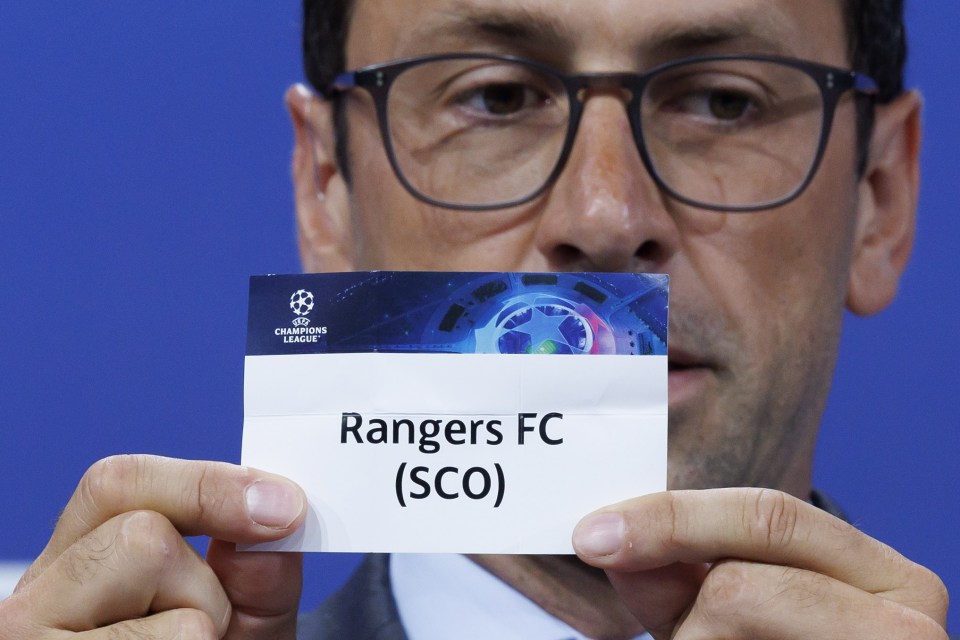 Person holding a Rangers FC (SCO) Champions League ticket.