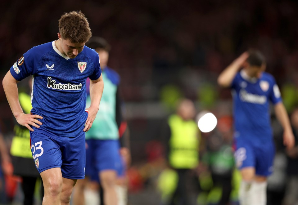 Mikel Jaureguizar and Athletic Club teammates leaving the pitch after a soccer match.