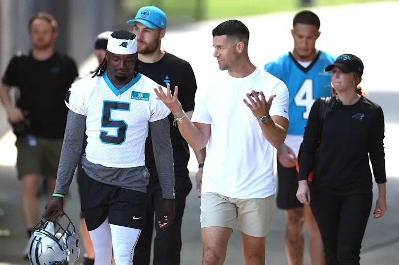 Carolina Panthers head coach Dave Canales, right, talks with cornerback Keion Corseen, left, as they walk to the team’s rookie minicamp practice on Friday, May 9, 2025. JEFF SINER/jsiner@charlotteobserver.com