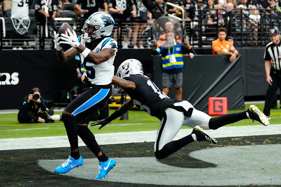 LAS VEGAS, NEVADA - SEPTEMBER 22: Diontae Johnson #5 of the Carolina Panthers catches a pass in front of Jack Jones #18 of the Las Vegas Raiders for a second quarter touchdown at Allegiant Stadium on September 22, 2024 in Las Vegas, Nevada. (Photo by Louis Grasse/Getty Images)