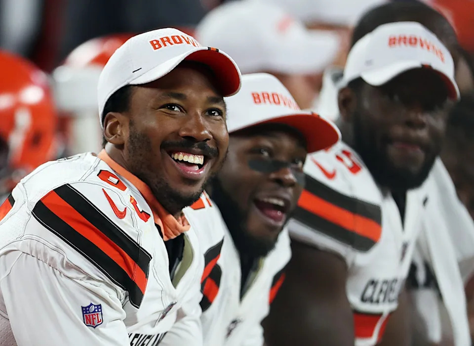 Cleveland Browns defensive end Myles Garrett (left) laughs as he watches a video on the scoreboard during a preseason game against Washington on Aug. 8, 2019, in Cleveland, Ohio.