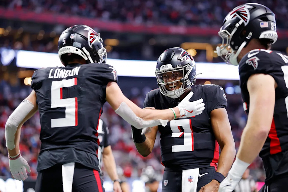ATLANTA, GEORGIA - JANUARY 05: Drake London #5 of the Atlanta Falcons celebrates after scoring a touchdown with teammate Michael Penix Jr. #9 during the second quarter against the Carolina Panthers at Mercedes-Benz Stadium on January 05, 2025 in Atlanta, Georgia. (Photo by Todd Kirkland/Getty Images)