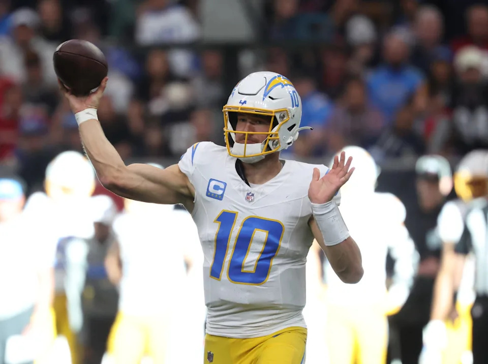 Jan 11, 2025; Houston, Texas, USA; Los Angeles Chargers quarterback Justin Herbert (10) passes the ball during the first quarter against the Houston Texans in an AFC wild card game at NRG Stadium. Mandatory Credit: Troy Taormina-Imagn Images