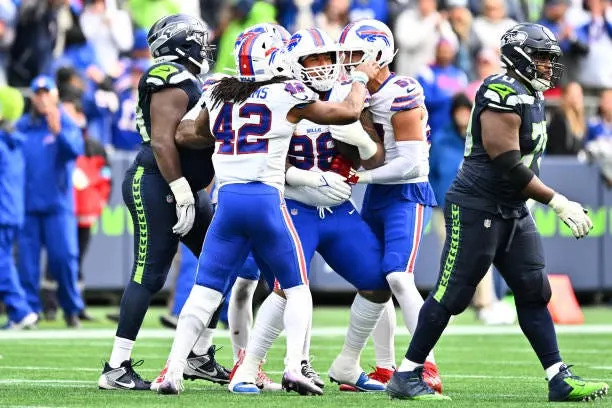 SEATTLE, WASHINGTON - OCTOBER 27: Austin Johnson #98 of the Buffalo Bills celebrates with teammates after an interception during the third quarter against the Seattle Seahawks at Lumen Field on October 27, 2024 in Seattle, Washington. (Photo by Jane Gershovich/Getty Images)