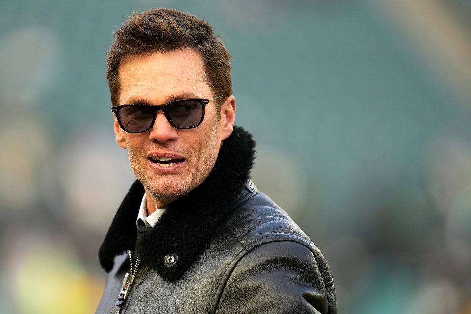 Tom Brady wearing sunglasses and a leather jacket.