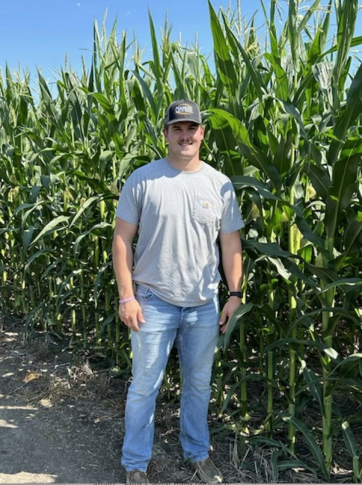 Man standing in a cornfield.
