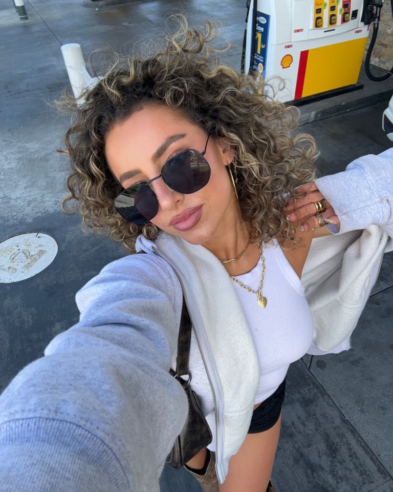Selfie of Gia Duddy at a gas station.