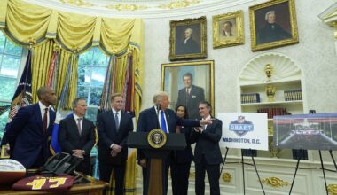 Interior Secretary Doug Burgum, from right, District of Columbia Mayor Muriel Bowser, and from left, Secretary of Housing and Urban Development Scott Turner, Washington Commanders owner Josh Harris and NFL Commissioner Roger Goodell listen as President Donald Trump speaks during an event to announce that the 2027 NFL Draft will be held on the National Mall, in the Oval Office of the White House, Monday, May 5, 2025, in Washington. (AP Photo/Alex Brandon)