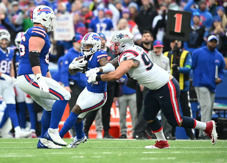 Dec 31, 2023; Orchard Park, New York, USA; Buffalo Bills wide receiver Stefon Diggs (14) is tackled by New England Patriots defensive end Lawrence Guy Sr.Mark Konezny-USA TODAY Sports