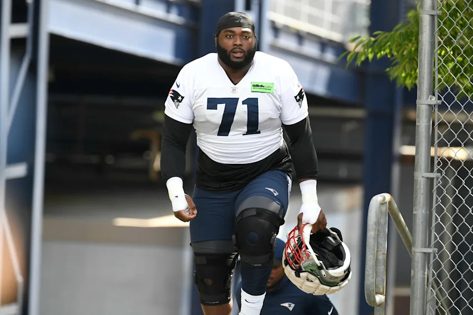 New England Patriots guard Mike Onwenu (71) walks to the practice field at the Patriots training camp at Gillette Stadium.Eric Canha-Imagn Images