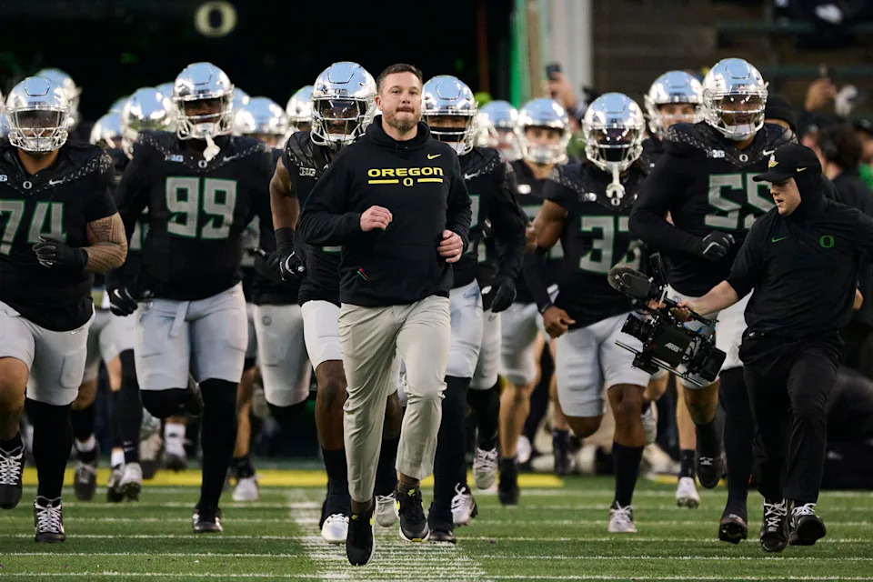 Nov 30, 2024; Eugene, Oregon, USA; Oregon Ducks head coach Dan Lanning runs out with the team before a game against the Washington Huskies at Autzen Stadium. Mandatory Credit: Troy Wayrynen-Imagn Images