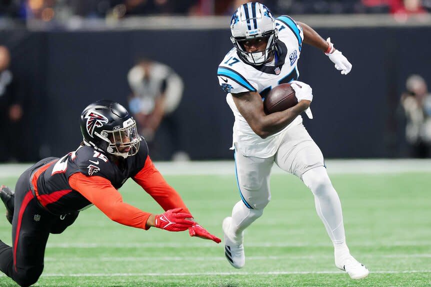 Xavier Legette running after a catch as an Atlanta Falcons player tries to tackle him.