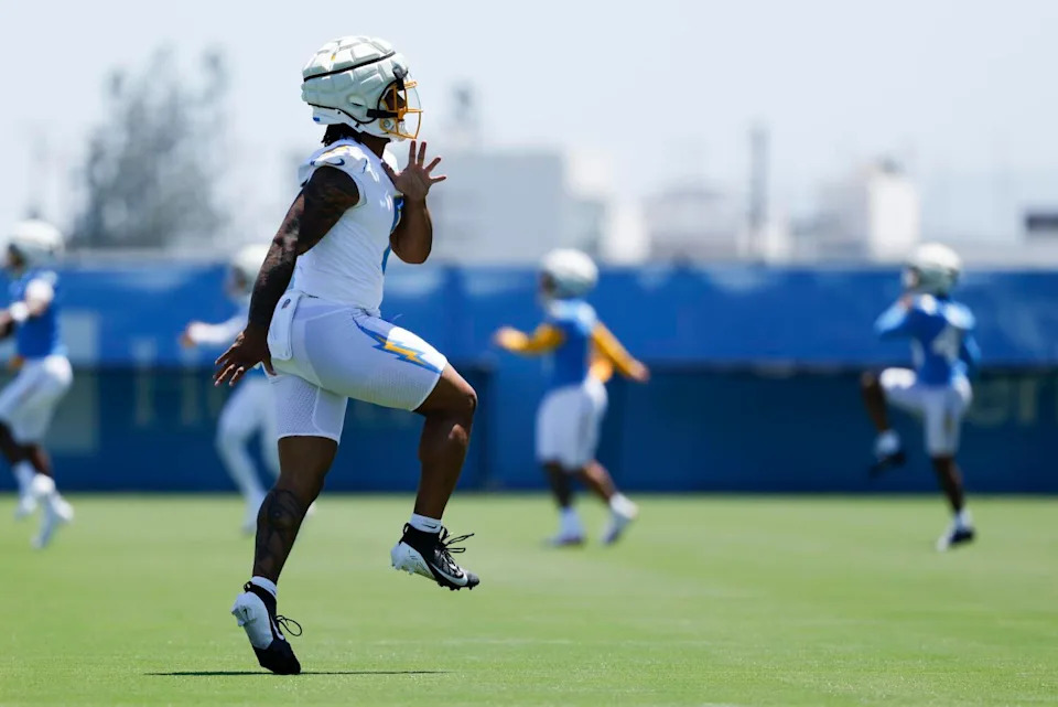 Chargers rookie running back Omarion Hampton stretches by doing high-knee lifts during a drill at organized team activities.