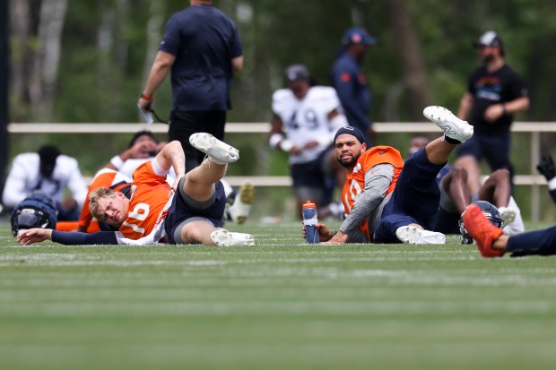 Bears quarterbacks Austin Reed, left, and Caleb Williams stretch during practice at Halas Hall on Tuesday, June 3, 2025. (Eileen T. Meslar/Chicago Tribune)