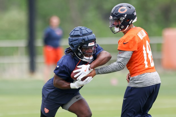 Bears quarterback Caleb Williams hands the ball off to running back Kyle Monangai during practice at Halas Hall on Tuesday, June 3, 2025. (Eileen T. Meslar/Chicago Tribune)