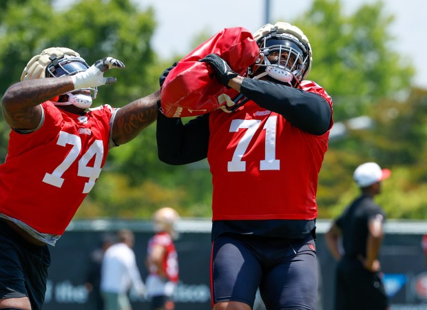 San Francisco 49ers' Trent Williams (71) practices with San Francisco 49ers' Spencer Burford (74) at Levi's Stadium practice field in Santa Clara, Calif., on Wednesday, June 4, 2025. (Shae Hammond/Bay Area News Group)
