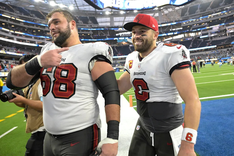 Dec 15, 2024; Inglewood, California, USA; Tampa Bay Buccaneers guard Ben Bredeson (68) and quarterback Baker Mayfield (6) celebrate as the leave the field after defeating the Los Angeles Chargers at SoFi Stadium. Mandatory Credit: Jayne Kamin-Oncea-Imagn Images