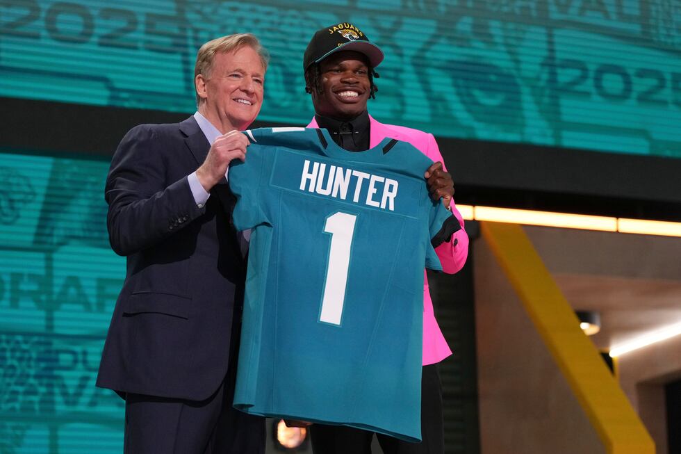Colorado wide receiver Travis Hunter, right, poses with NFL Commissioner Roger Goodell after...