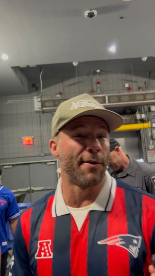 Man in Patriots jersey talking.