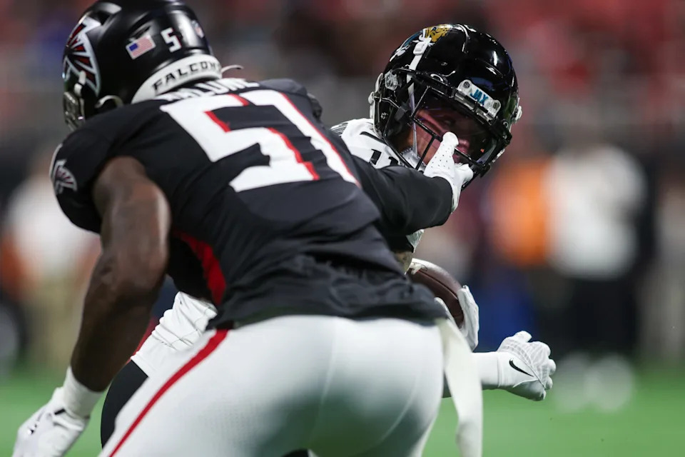 Falcons LB DeAngelo Malone grabs the facemask of a Jacksonville Jaguar. Brett Davis-Imagn Images
