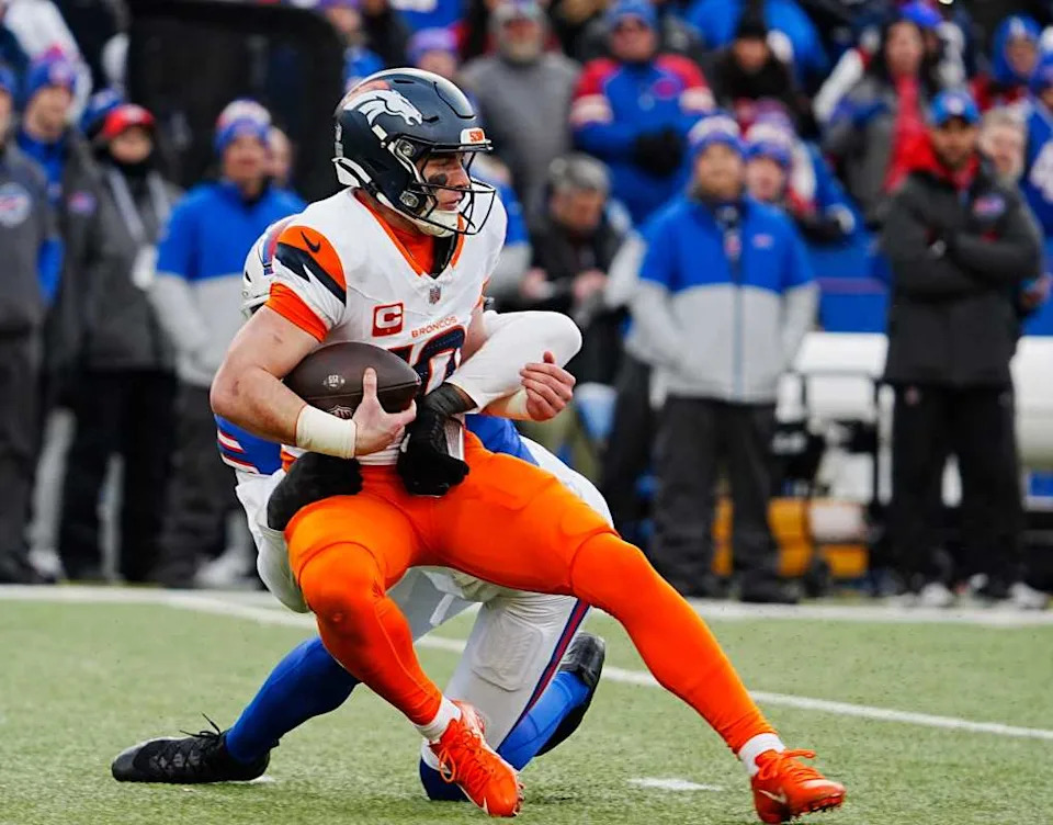 Bo Nix attempts to shake a tackle vs. Buffalo on Jan. 12, 2025. © Tina MacIntyre-Yee&sol;Democrat and Chronicle &sol; USA TODAY NETWORK via Imagn Images