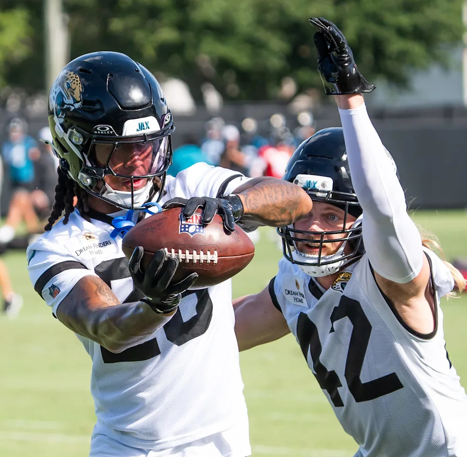 Jacksonville Jaguars safety Antonio Johnson (26) catches a ball during a drill as Jacksonville Jaguars safety Andrew Wingard (42) tries to defend him during the Jacksonville Jaguars’ third mandatory minicamp Thursday June 12, 2025 at the Miller Electric Center in Jacksonville, Fla. [Doug Engle/Florida Times-Union]