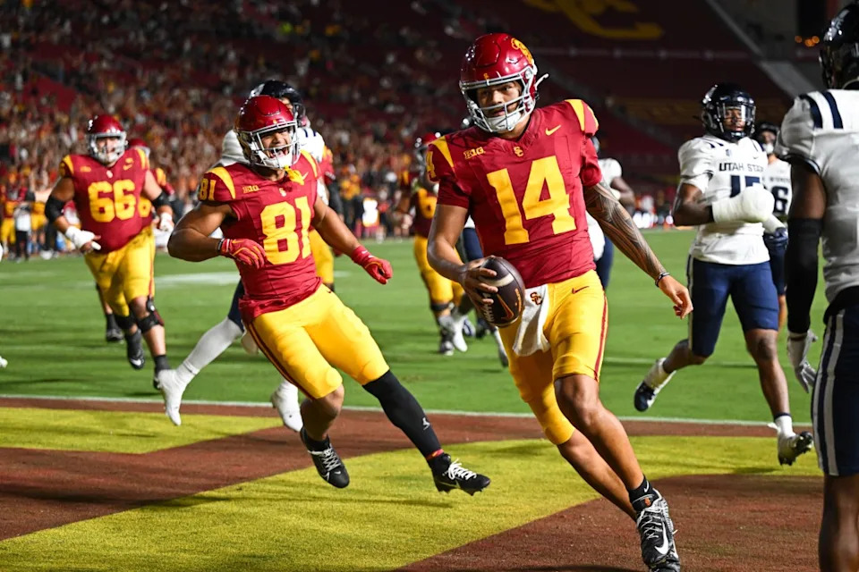 USC Trojans quarterback Jayden Maiava (14) scores a touchdown against the Utah State Aggies at Los Angeles Memorial Coliseum on Sept. 7, 2024.Jonathan Hui-Imagn Images