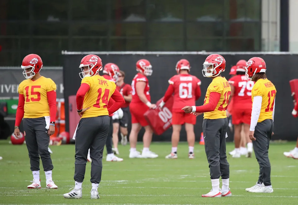 KANSAS CITY, MISSOURI - MAY 29: The Chiefs quarterbacks Patrick Mahomes #15, Gardner Minshew #17, Chris Oladokun #19 and Bailey Zappe #14 meet on the field as they await the next drill during the Kansas City Chiefs OTAs at The University of Kansas Health System Training Complex on May 29, 2025 in Kansas City, Missouri. (Photo by Bruce Yeung/Getty Images)