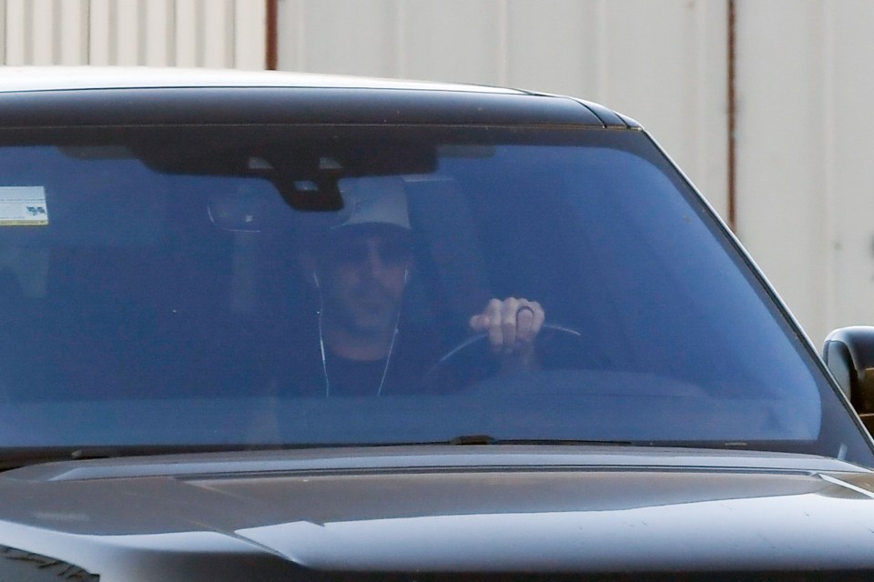 Aaron Rodgers driving a car.