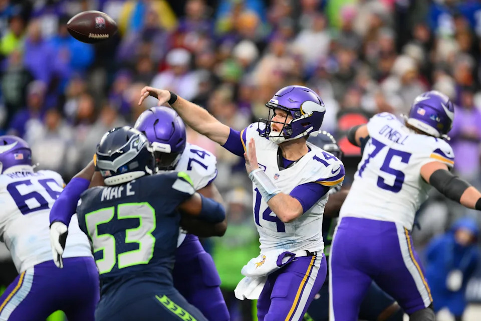 Dec 22, 2024; Seattle, Washington, USA; Minnesota Vikings quarterback Sam Darnold (14) passes the ball against the Seattle Seahawks during the second half at Lumen Field. Mandatory Credit: Steven Bisig-Imagn Images