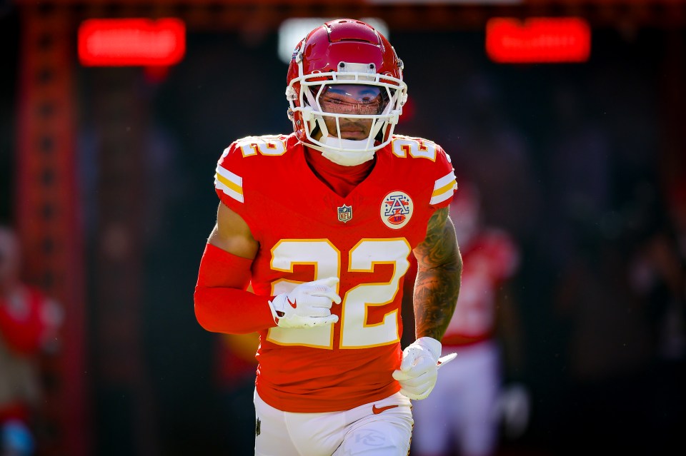 Kansas City Chiefs player #22 running onto the field.